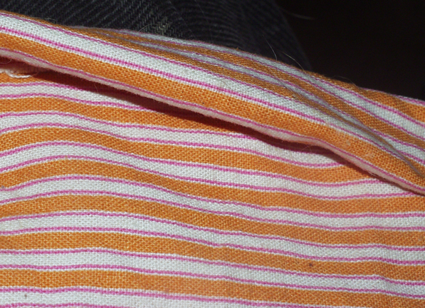 Picture of
            mask's top edge folded back.
